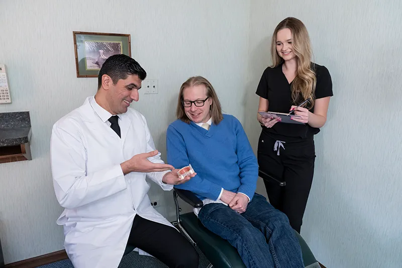 The Dr. and assistant talking with a patient