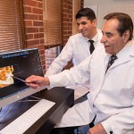 both oral surgeons looking at scans on computer