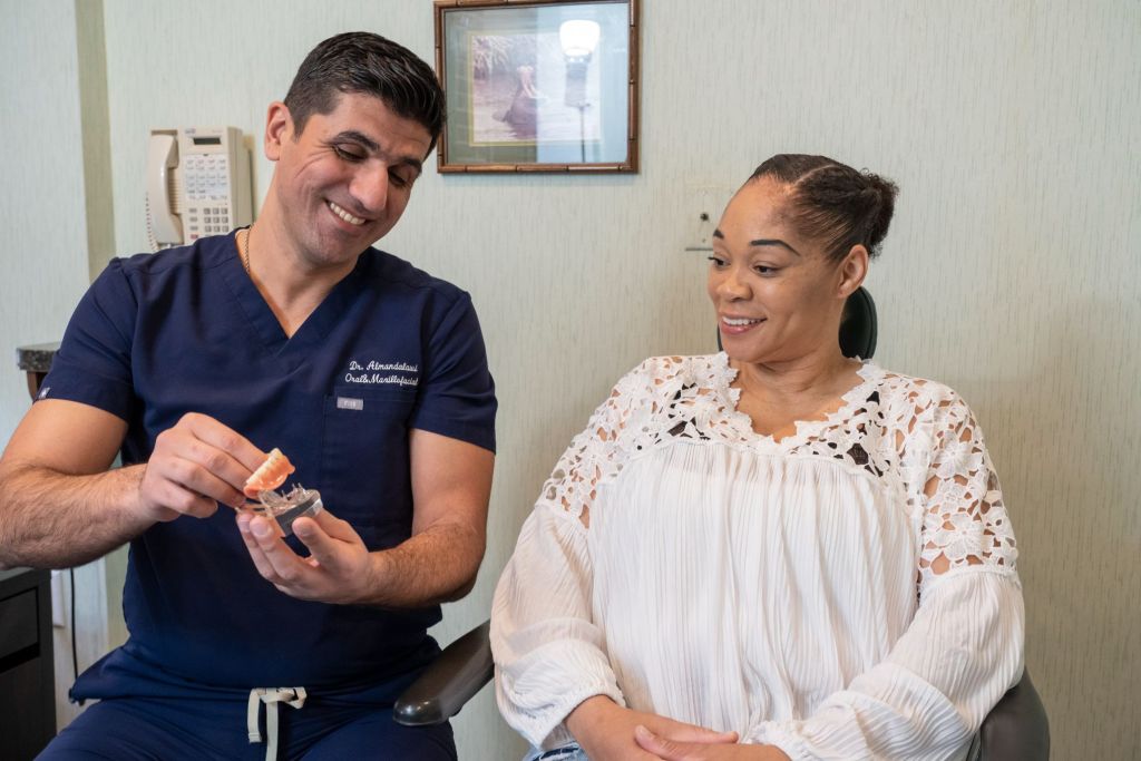 Dr. A showing patient a model of teeth