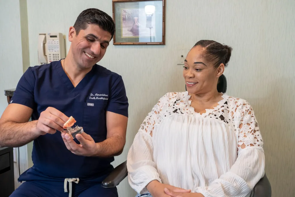 Dr. A showing patient a model of teeth