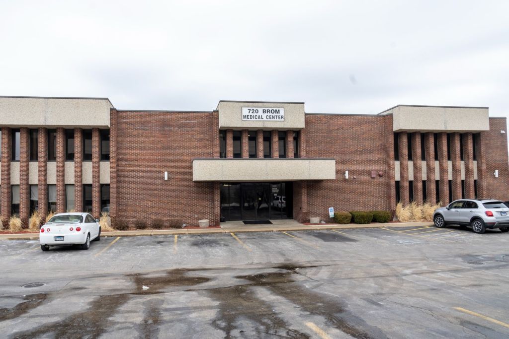 Office building front entrance and parking lot view