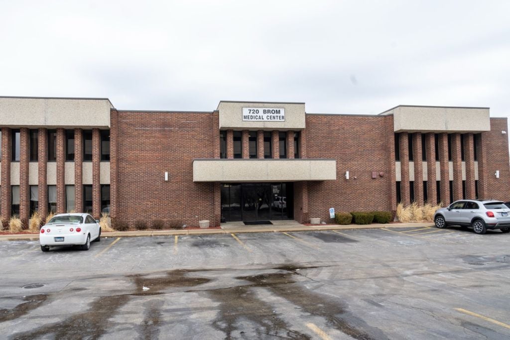 Office building front entrance and parking lot view