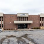 Office building front entrance and parking lot view