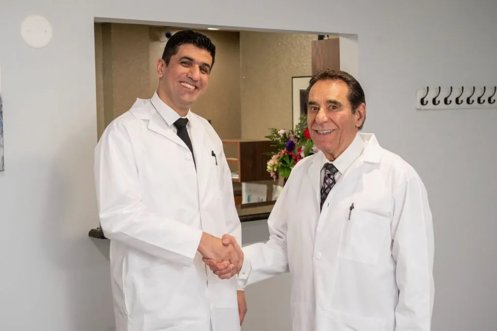 both oral surgeons shaking hands