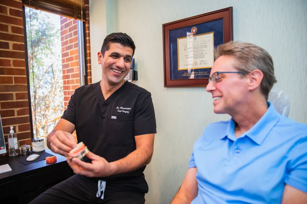 Dr. A showing patient a mock up of smile