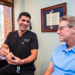 Dr. A showing patient a mock up of smile